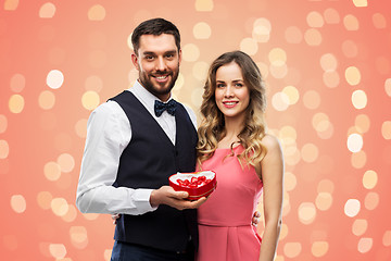 Image showing happy couple with chocolate box in shape of heart