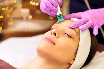 Image showing woman having microdermabrasion facial treatment