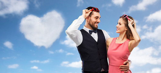 Image showing happy couple in heart-shaped sunglasses