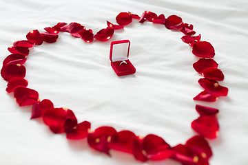 Image showing heart made of petals and diamond ring in gift box