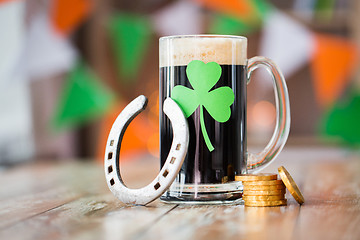 Image showing shamrock on glass of beer, horseshoe and coins