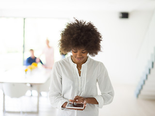 Image showing Portrait of  black casual businesswoman using tablet  with cowor