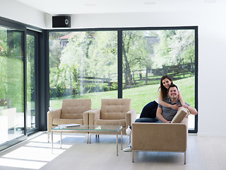 Image showing young handsome couple hugging on the sofa