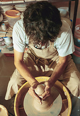 Image showing Creating a jar or vase of white clay close-up. Master crock.