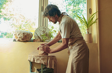 Image showing Creating a jar or vase of white clay close-up. Master crock.