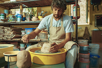 Image showing Creating a jar or vase of white clay close-up. Master crock.