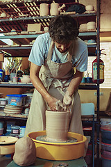 Image showing Creating a jar or vase of white clay close-up. Master crock.