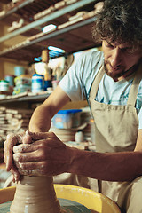 Image showing Creating a jar or vase of white clay close-up. Master crock.