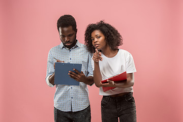 Image showing Two african students with folders in t-shirts together. Stylish girl with Afro hairstyle and her boyfriend.