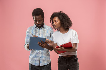 Image showing Two african students with folders in t-shirts together. Stylish girl with Afro hairstyle and her boyfriend.