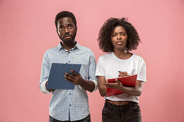 Image showing Two african students with folders in t-shirts together. Stylish girl with Afro hairstyle and her boyfriend.