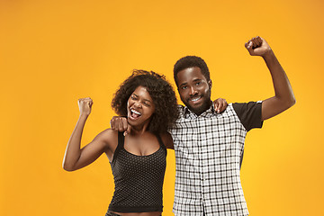 Image showing Winning success couple celebrating being a winner. Dynamic energetic image of afro models