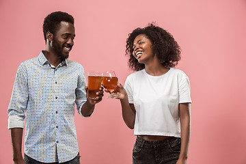 Image showing The afro couple or happy young people laughing and drinking beer at studio