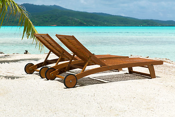 Image showing tropical beach with palm tree and sunbeds