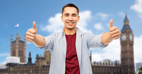 Image showing happy young man showing thumbs up over london