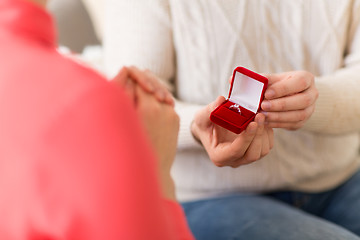 Image showing man giving diamond ring to woman on valentines day