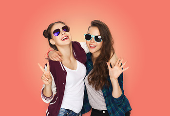 Image showing smiling teenage girls in sunglasses showing peace