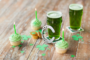 Image showing glass of beer, cupcakes, horseshoe and gold coins