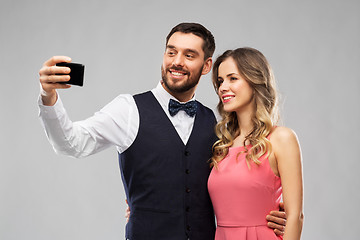 Image showing happy couple taking selfie by smartphone