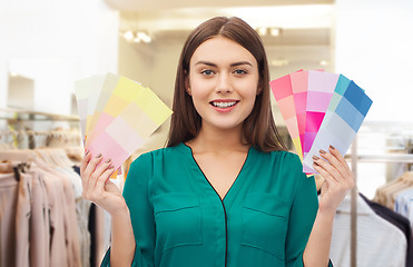 Image showing woman with color swatches at clothing store