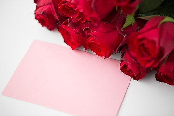 Image showing close up of red roses and letter or note