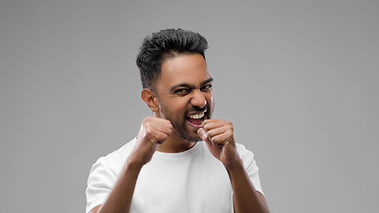 Image showing indian man pretending fighting or boxing