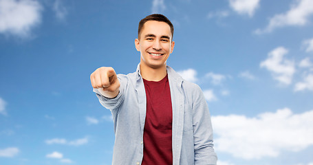 Image showing man pointing finger to you over blue sky