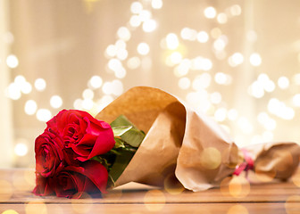 Image showing close up of red roses bunch wrapped into paper