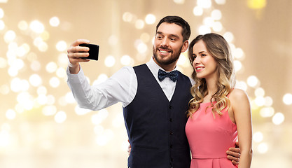 Image showing happy couple taking selfie by smartphone