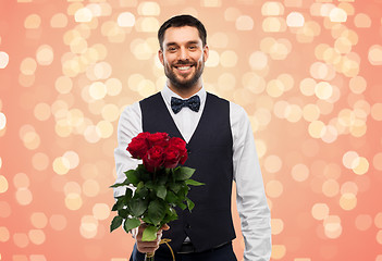 Image showing happy man with bunch of red roses