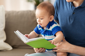 Image showing baby boy and father with book at home