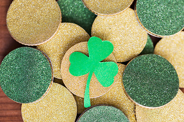 Image showing close up of golden coins and green shamrock leaf