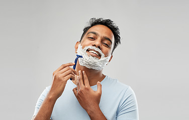 Image showing indian man shaving beard with razor blade