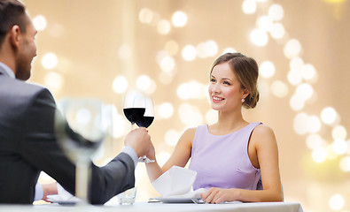 Image showing young couple with glasses of wine at restaurant