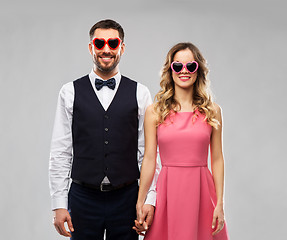 Image showing happy couple in heart-shaped sunglasses