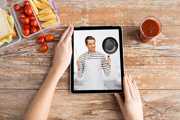 Image showing woman watching cooking video on tablet computer