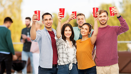 Image showing group of friends toasting drinks at rooftop party