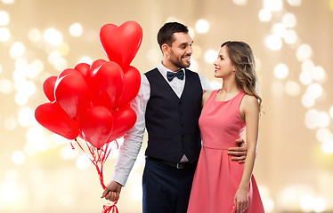 Image showing happy couple with red heart shaped balloons