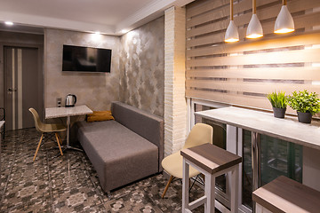 Image showing The interior of a small living room in the hotel room, combined with kitchen
