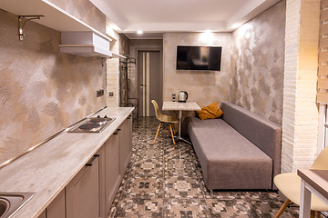 Image showing The interior of a small living room in the hotel room, combined with kitchen