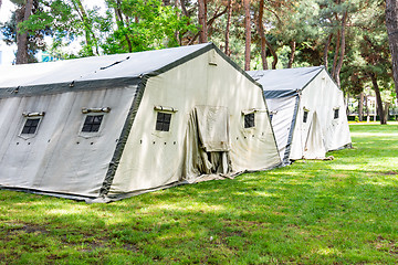 Image showing Big tents of the Ministry of Emergency Situations, laid out on the lawn in the forest plantation