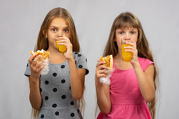 Image showing Two girls write dried meat juice