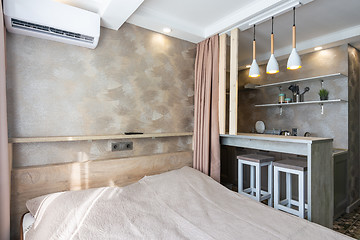 Image showing View of the bed, bar and kitchen in a small hotel room