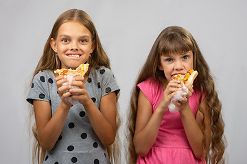 Image showing Two girls are funny eating bread