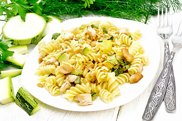 Image showing Fusilli with chicken and zucchini in plate on board