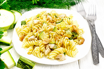 Image showing Fusilli with chicken and zucchini in plate on white board