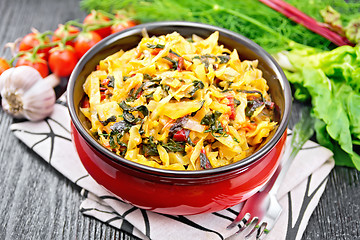 Image showing Cabbage stew with chard in bowl on dark board