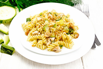 Image showing Fusilli with chicken and zucchini in two plates on light board