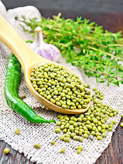 Image showing Mung beans in spoon on wooden board