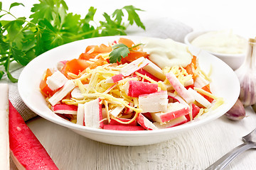 Image showing Salad of surimi and tomatoes on board